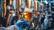 © Helen - Close-up Hand holding a beer glass in a brewery with brewing equipment in the background. Beverage production and quality control background design for poster, banner.