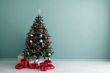 Wall Mural - Christmas tree with gifts on the floor in a room against a green wall, in a minimalistic style, free space for text