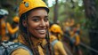 © JoxyAimages - A young woman with braided hair beams a bright smile while wearing a safety helmet at an outdoor adventure activity park, conveying enthusiasm and a love for thrilling experiences.
