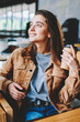 © BullRun - Two happy female persons enjoying live communication and morning takeaway coffee at university cafeteria, trendy smiling hipster girls holding caffeine beverage and discussing hobby on leisure