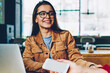 © BullRun - Selective focus on smiling hipster girl in eyewear looking to her female friend sitting near and enjoying positive communication together after studying with technology at university campus