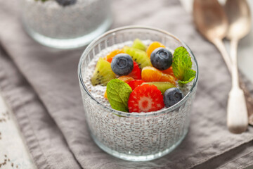 Wall Mural - Chia puddind with fruit berry salad in bowl on grey background. Healthy breakfast