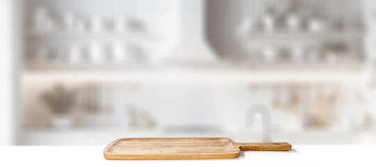 Wall Mural - Wooden cutting board with blurred bright kitchen interior. Natural window daily sunlight. Copy space for products.