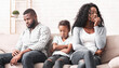 © Prostock-studio - Upset black girl suffer from family conflict, sitting between offended parents, feeling depressed and frustrated.