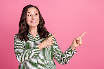 Wall Mural - Photo of nice aged lady point fingers empty space wear striped shirt isolated on pink color background