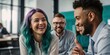 © Hashim - Teal-haired woman laughing with blur colleagues during relaxed office team meeting