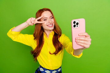 Wall Mural - Photo of cheerful positive cute woman wear yellow trendy clothes make video vlog isolated on green color background