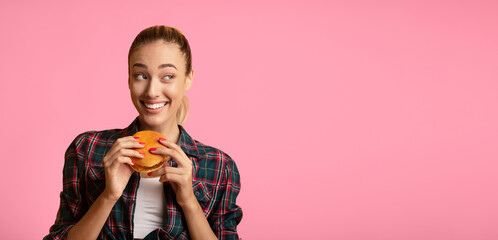 Canvas Print - Cheat Meal. Pretty Lady Eating Hamburger Over Yellow Studio Background. Free Space