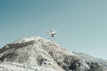 Aufkleber - Aerial view of a small white drone flying above a mountain range with rugged terrain and scenic views
