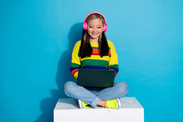 Sticker - Full body photo of attractive young woman sit cube headphones netbook dressed stylish striped clothes isolated on blue color background