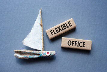 Flexible Office symbol. Concept word Flexible Office on wooden blocks. Beautiful grey background with boat. Business and Flexible Office concept. Copy space