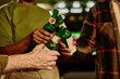 © pressmaster - Hands of three young intercultural people clinking with bottles of beer standing in front of camera while toasting for Saint Patrick day