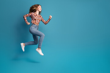 Poster - Full body portrait of nice young girl jump run empty space wear top isolated on blue color background