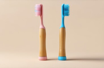 Wall Mural - Two eco friendly pink and blue natural bamboo toothbrushes on beige background. Health care, copy space. Zero waste concept.