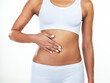 © Chanelle2000/peopleimages.com - Hand, stomach and body of woman in studio with weightloss for fitness, diet or digestion. Gut health, nutrition and abdomen of slim female person in underwear for wellness detox by white background.
