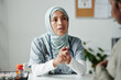 © pressmaster - Young female clinician in hijab looking at patient and giving her medical advice or consulting her about prescribed medicaments