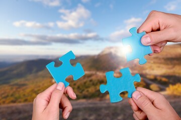 Canvas Print - Teamwork and partnership Hands holding a piece of  jigsaw puzzle