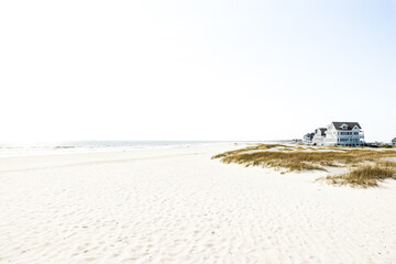 Poster - Beach house with white sand and blue sky