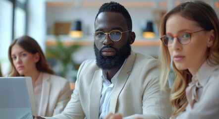 Businessman With Beard and Glasses Looking at Camera