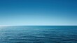 © Enigma - Calm, deep blue ocean water is meeting a clear sky at the horizon on a sunny day, ideal for backgrounds about nature, travel, and relaxation
