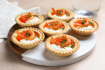 Wall Mural - Delicious canapes with shrimps, red caviar and cream cheese on light table