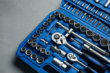 Sticker - Different auto mechanic's tools in plastic box on grey table, above view