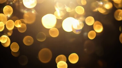 Poster - A close-up shot of festive golden bokeh lights against a dark background