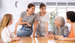 © JackF - Friendly interested young girl, student of adult school, taking part in discussion of study topics with group of female coursemates of various ages sitting around table