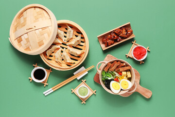 Wall Mural - Composition with tasty Chinese food and chopsticks on green background