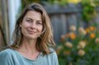 © Adriana - Smiling mature attractive housewife posing at her home backyard looking at the camera