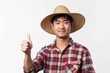 © VolumeThings - Asian man farmer giving thumbs up gesture Intelligent farmer posed on white background