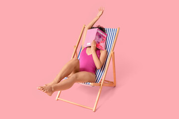 Sticker - Young African-American woman with magazine sitting in deck chair on pink background