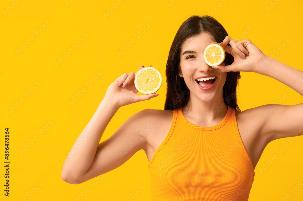 Beautiful young woman with lemon on color background