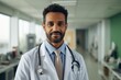 © Baba Images - Smiling portrait of a middle aged Indian doctor in hospital