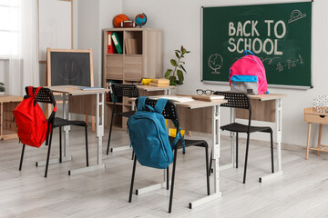 Sticker - School desks, backpacks and blackboard in modern classroom