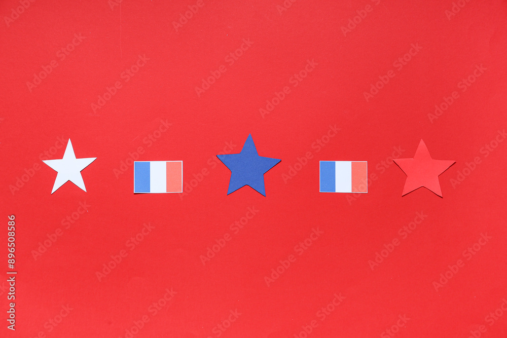 French flags and stars on red background. Bastille Day celebration