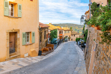 A colorful, winding hillside street in the picturesque village of Ramatuelle, France, in the  Var Department of the Provence, Alpes Cote d'Azur region.