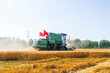 © zhengzaishanchu - combine harvester working on a wheat field
