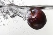 © Eyestetix Studio - Black Amber Plum falling into the water with a splash on a white background