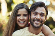© SometimesNever/peopleimages.com - Couple, happy and outdoor portrait with smile, bonding and love on vacation in park or garden. Care, support and young people together with travel, summer break and nature with embrace and romance