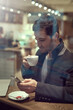 © Sanc/peopleimages.com - Business, man and coffee shop with smartphone for communication and networking on break. Male person, entrepreneur and browse internet or website for stock exchange, economic news and market share