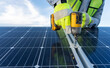 © Alan - close up on hands of an unrecognizable engineer installing and giving maintenance to solar panels using a drill, professional technician working on a roof with blue sky background