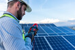 © Alan - engineer technician checking output voltage level of inverter, electrician measuring power on solar panels