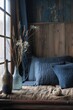 © Iigo - Interior of a rustic bedroom with pillows and blue linen
