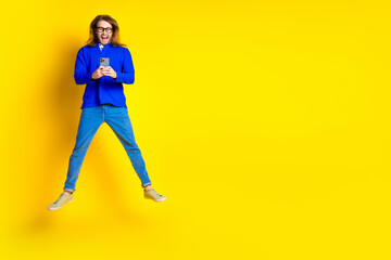 Poster - Photo of cheerful glad nice man wear stylish blue clothes read post empty space isolated on yellow color background