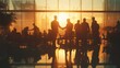 © Phichaphat - Silhouetted business professionals shaking hands in a modern office during sunset, symbolizing partnership and collaboration.