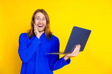 Poster - Photo of cheerful glad man wear trendy blue pullover buy credit isolated on yellow color background