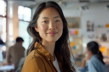 Wall Mural - Close-up of a woman smiling and looking confident in a creative workspace, team collaborating in the background, inspiring work environment, Portrait half-body, hyper-realistic, high detail,