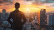 © 沈军 贡 - Businessman in suit standing with back to camera looking at cityscape from high building