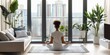 © YURIMA - Creating a serene home yoga environment involves selecting a quiet indoor location with calming urban scenery. This peaceful setting is ideal for a rejuvenating and introspective yoga session